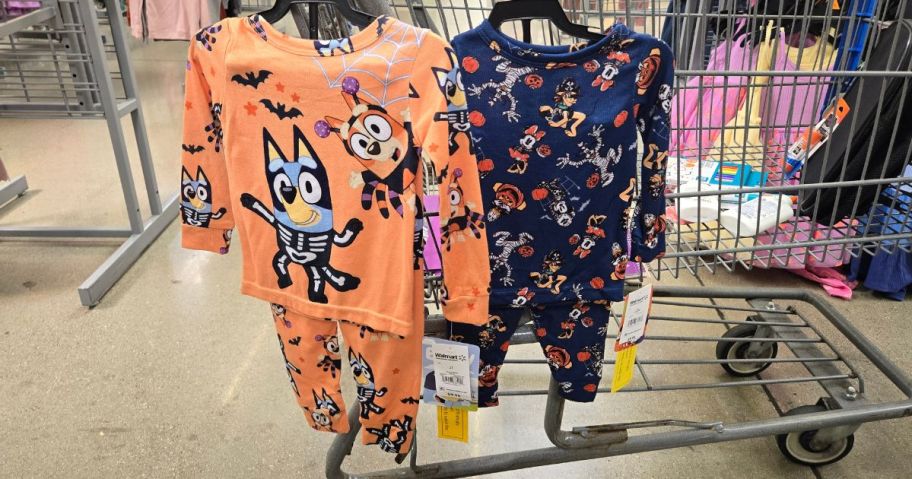 bluey and mickey halloween pajamas hanging on cart in store