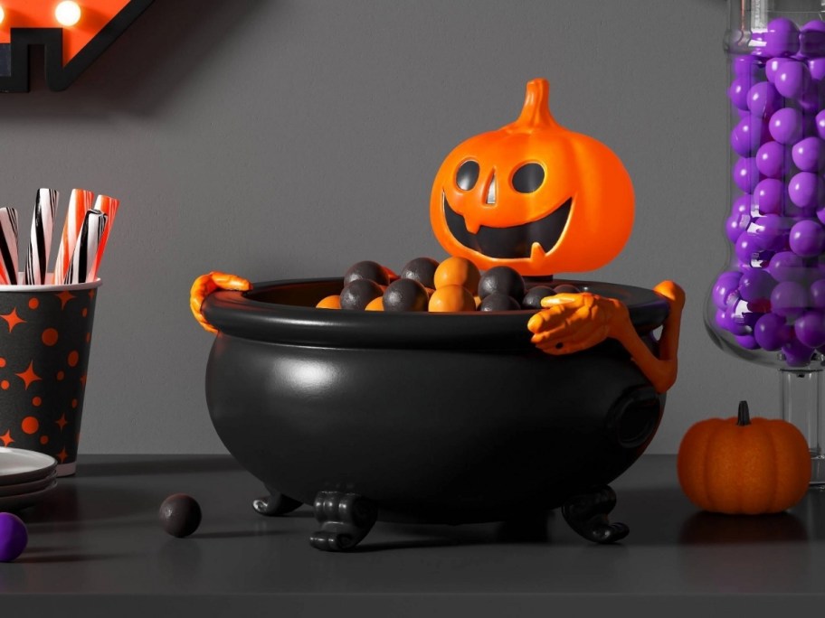 light and sound jack o lantern candy bowl on a mantle with other halloween decor