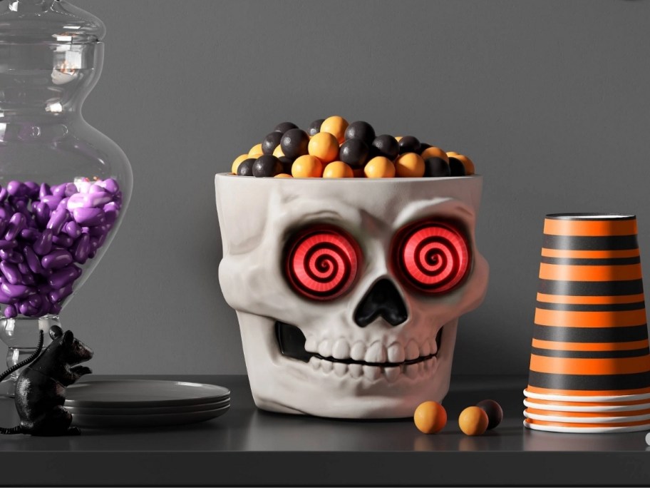light and sound skull candy bowl on a mantle with other halloween decor