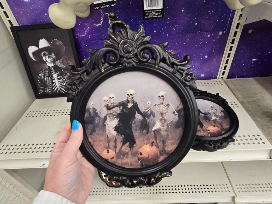 Framed Skeletons Wall Decor in hand in store
