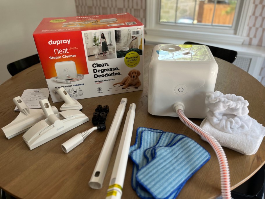 steam cleaner with all 25 accessories laid out on table
