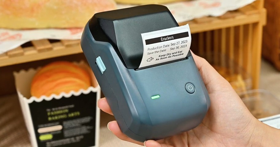 person holding a label maker