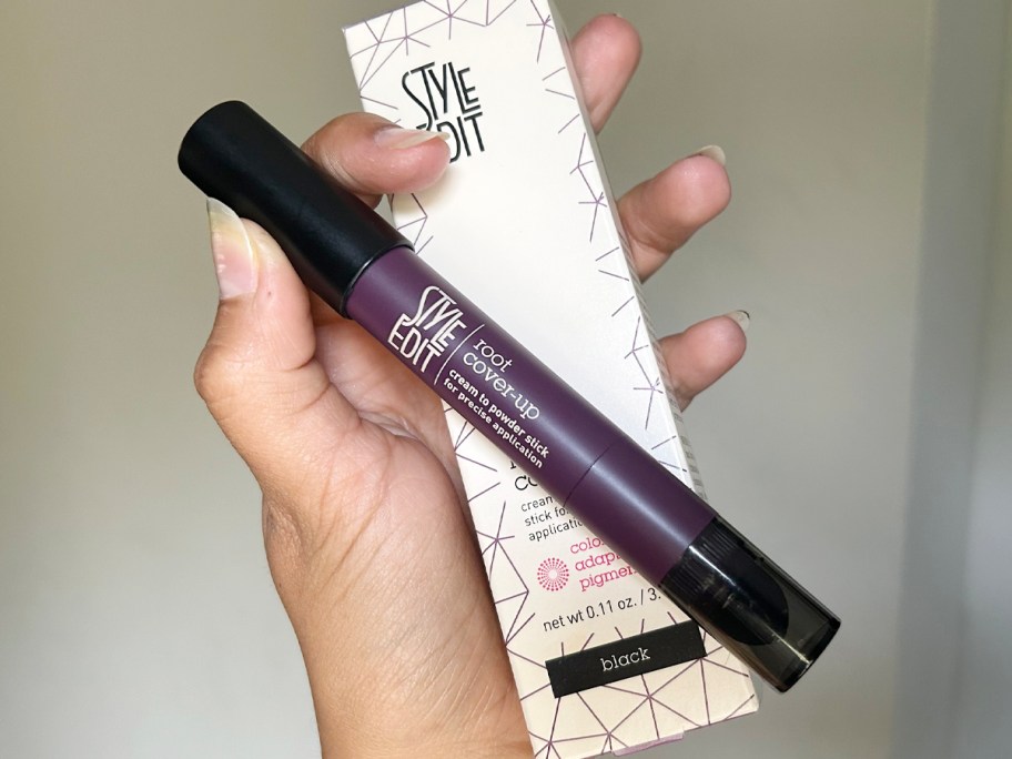 hand holding style edit touchup stick and box 