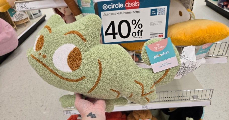 hand holding a Disney Pascal throw pillow at Target