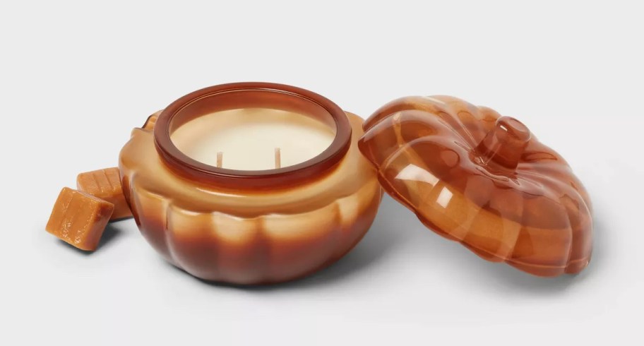 Stock photo of orange pumpkin glass candle