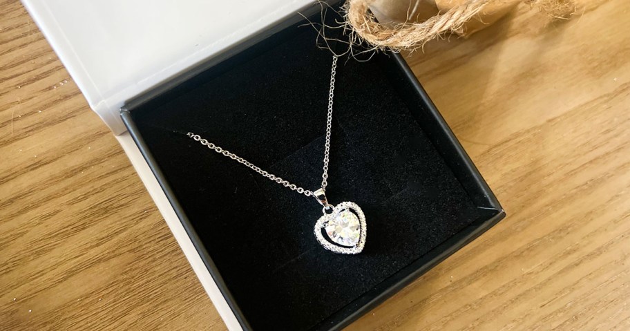 Amora 18k White Gold Plated Halo Heart Pendant Necklace with Simulated Diamond Crystals in a box on a table