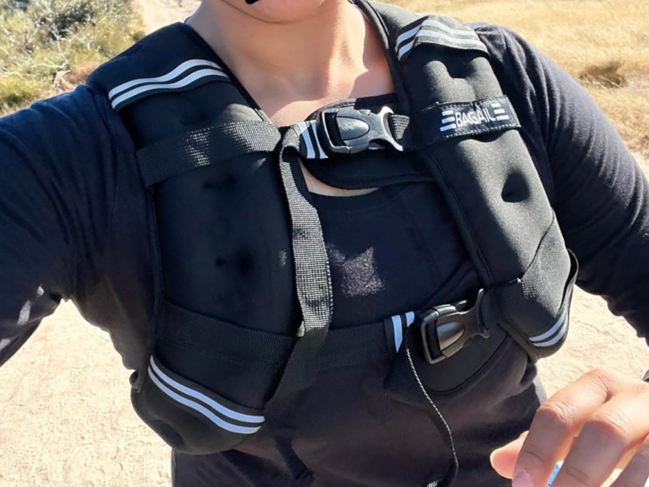 woman wearing a black weighted vest on a run