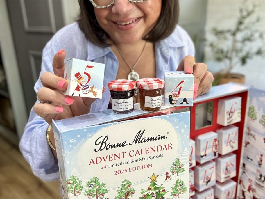 woman holding bonne maman jellies with advent calendar
