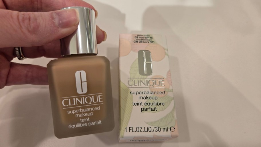hand holding Clinique Superbalanced Makeup Foundation bottle next to box