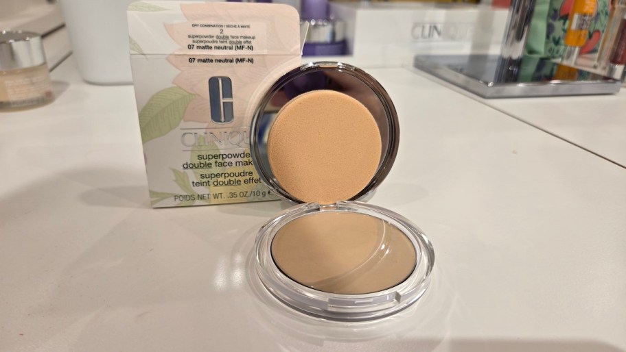 compact makeup mirror on white countertop