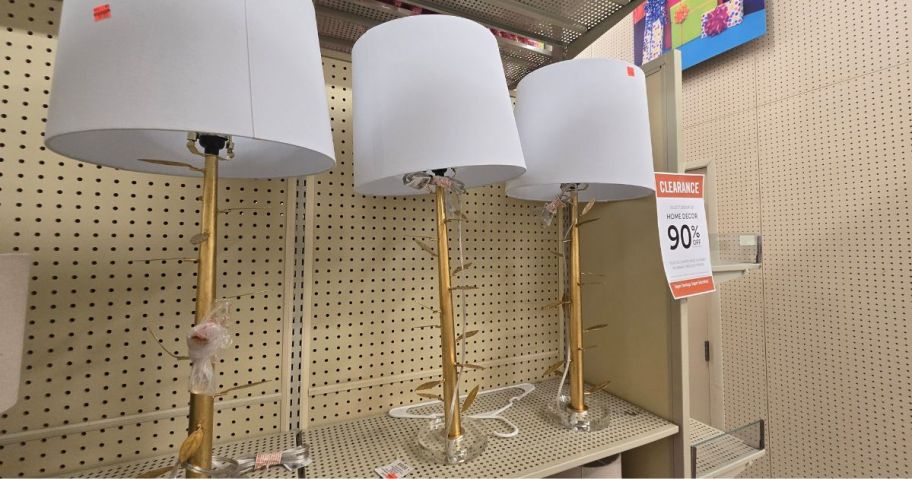 3 brass lamps in a store