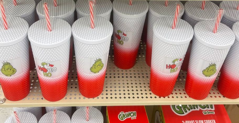 Several drink tumblers with the Grinch's face on them