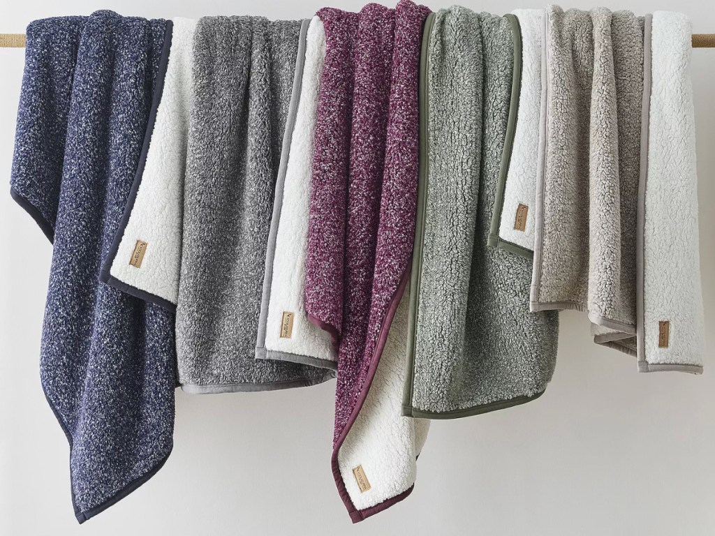 different colored Koolaburra by UGG Wiona Melange Sherpa Throws hanging on rack