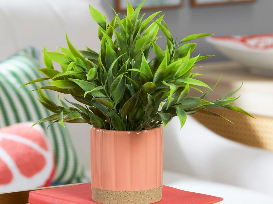 small artificial plant in a pink pot