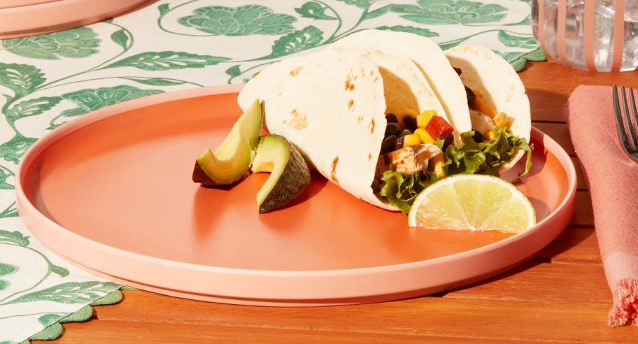 soft tacos on an orange dinner plate