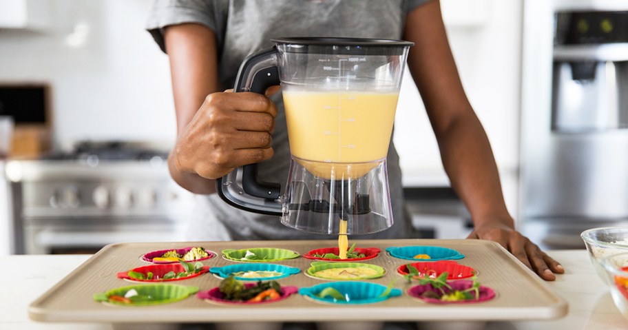 person using a batter dispenser for egg bites
