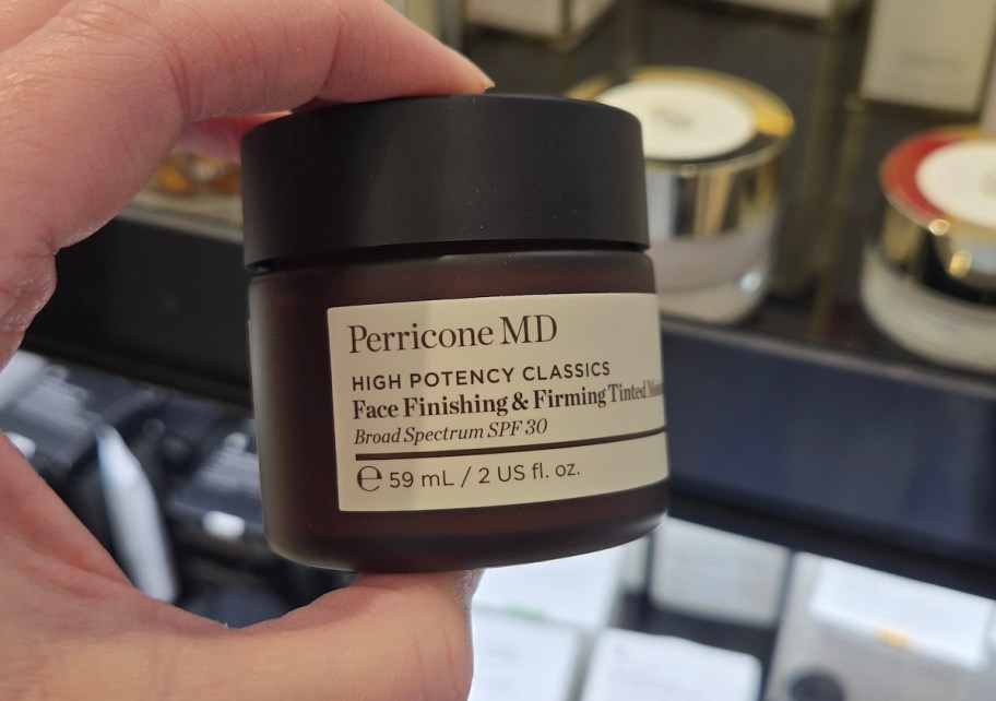 hand holding amber jar of Perricone MD High Potency Classics Face Finishing & Firming Moisturize