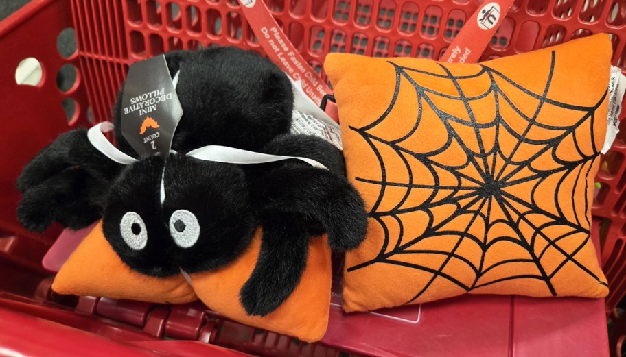 black spider pillow and orange pillow with spiderweb print