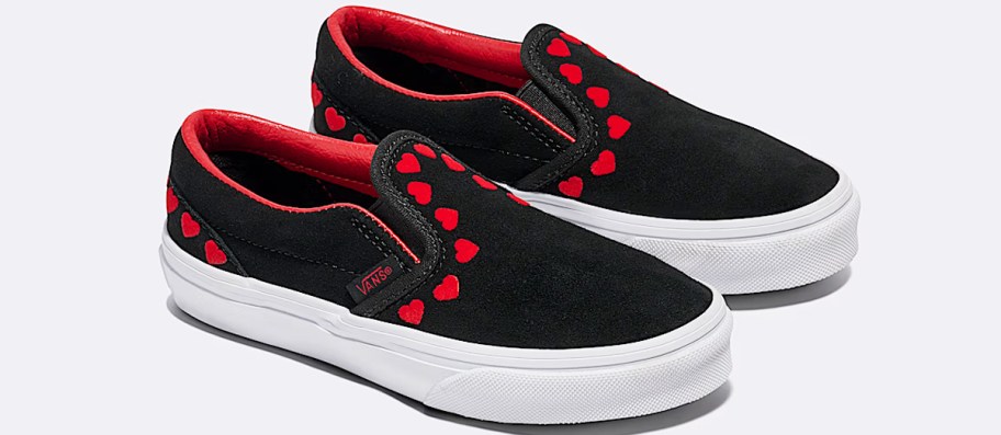 black slip on shoes with red hearts