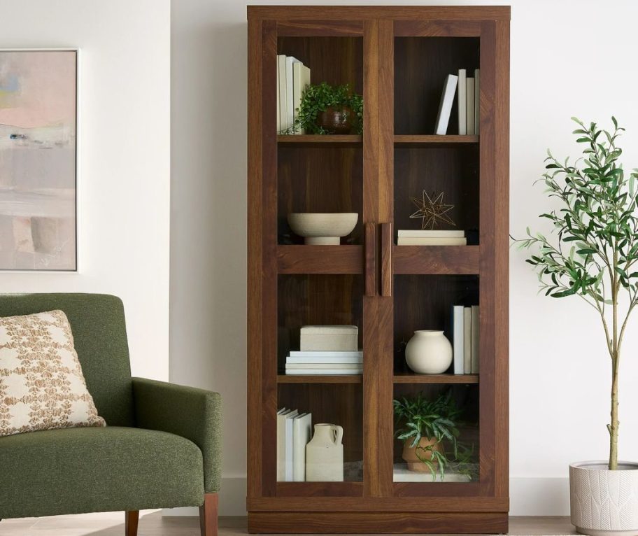 A darn brown Better Homes & Gardens Ezra Glass Door Storage Accent Cabinet