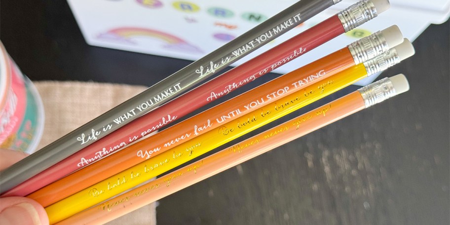 hand-holding 5 inspirational pencils 