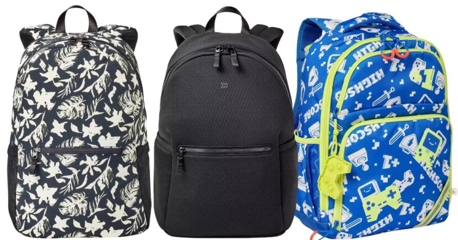 a black and white patterned backpack, a black backpack, and a blue patterned backpack