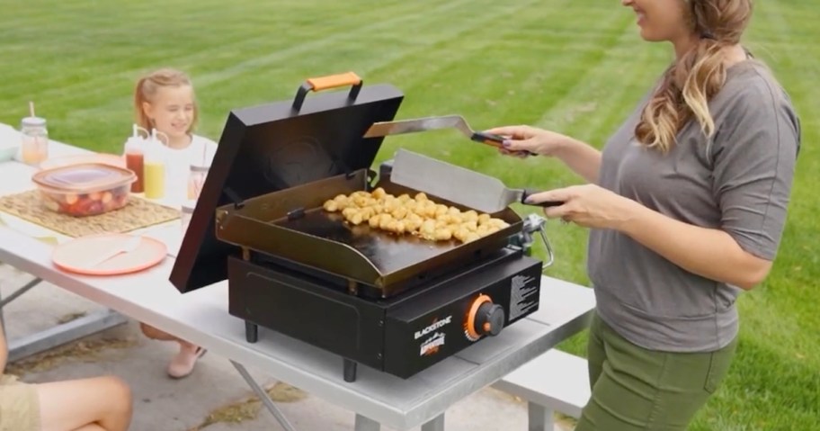 woman cooking on blackstone griddle