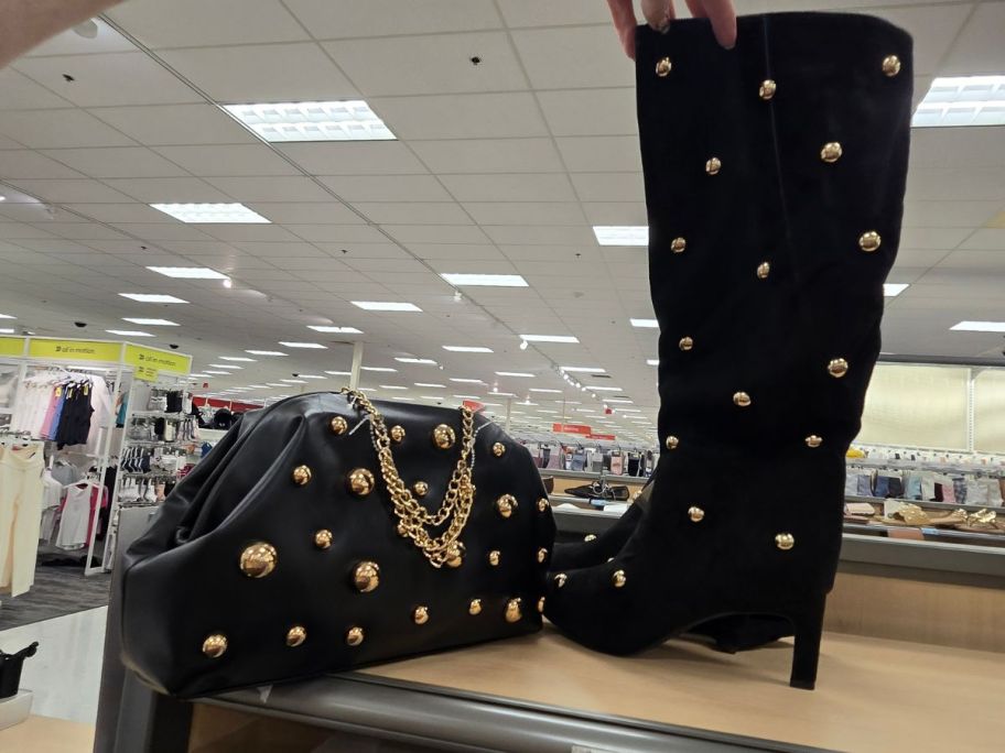 A New Day Oversized Clutch and boot on shelf in store