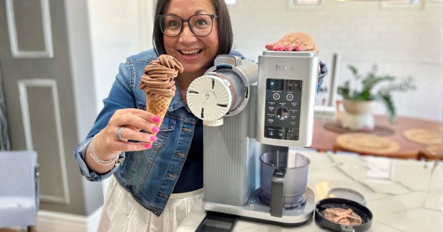 lina holding an ice cream cone and smiling in front of her ninja swirl machine