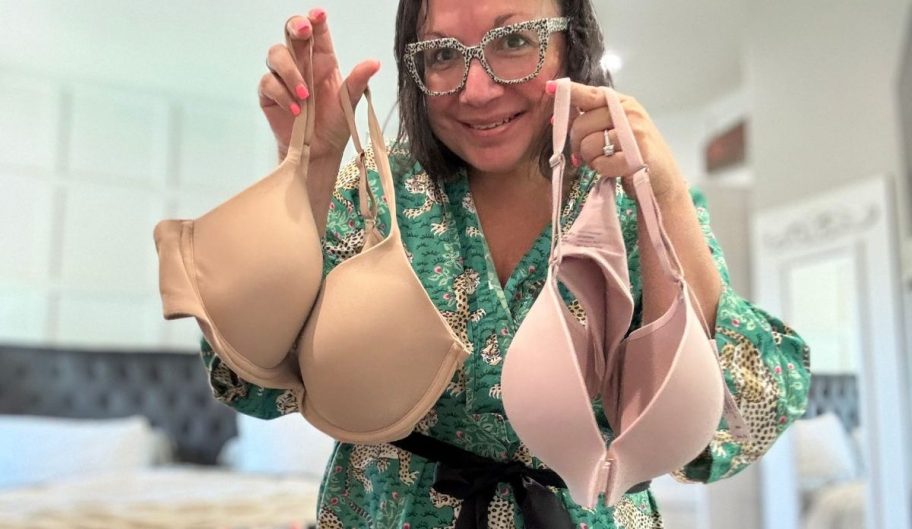 woman holding two bras 