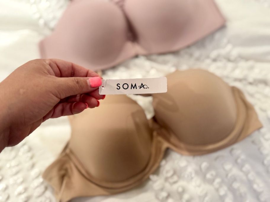 hand holding soma tag on bra