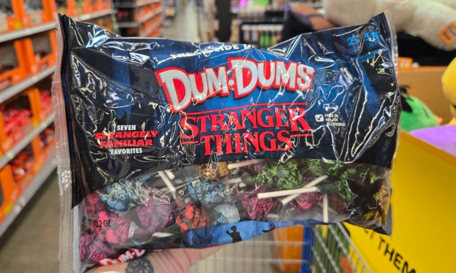 a womans hand holding a bag of candy
