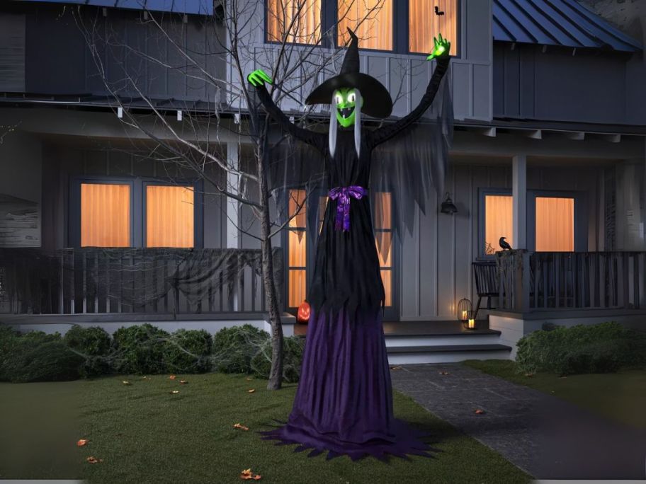 Hyde & Eek! 8' Halloween Towering Witch Decorative Prop on front lawn