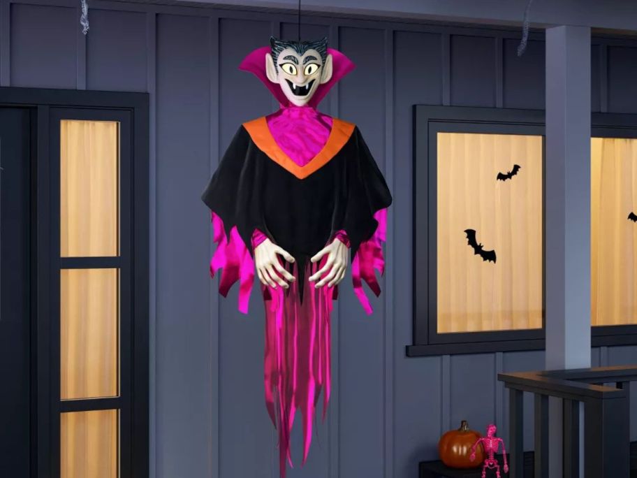 pink and orange Hyde & Eek! 60" Light & Sound Vampire Ghoul Halloween Decorative Prop on front porch
