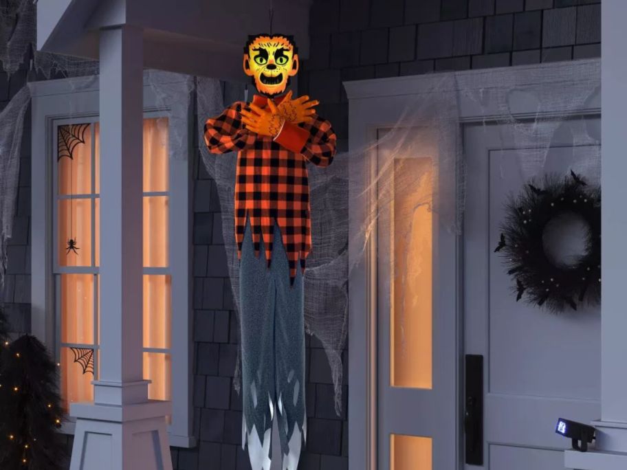 Hyde & Eek! 60" Animated Lit Werewolf Halloween Decorative Prop hanging on front porch