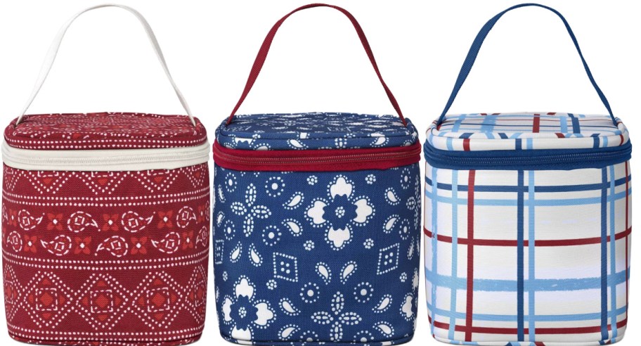 Three insulated soft coolers are displayed, each with a unique design: red with white patterns, blue with white motifs, and a blue-red plaid. Each has a handle on top.