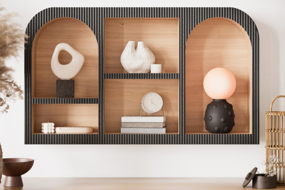 black wall mounted shelf with arches