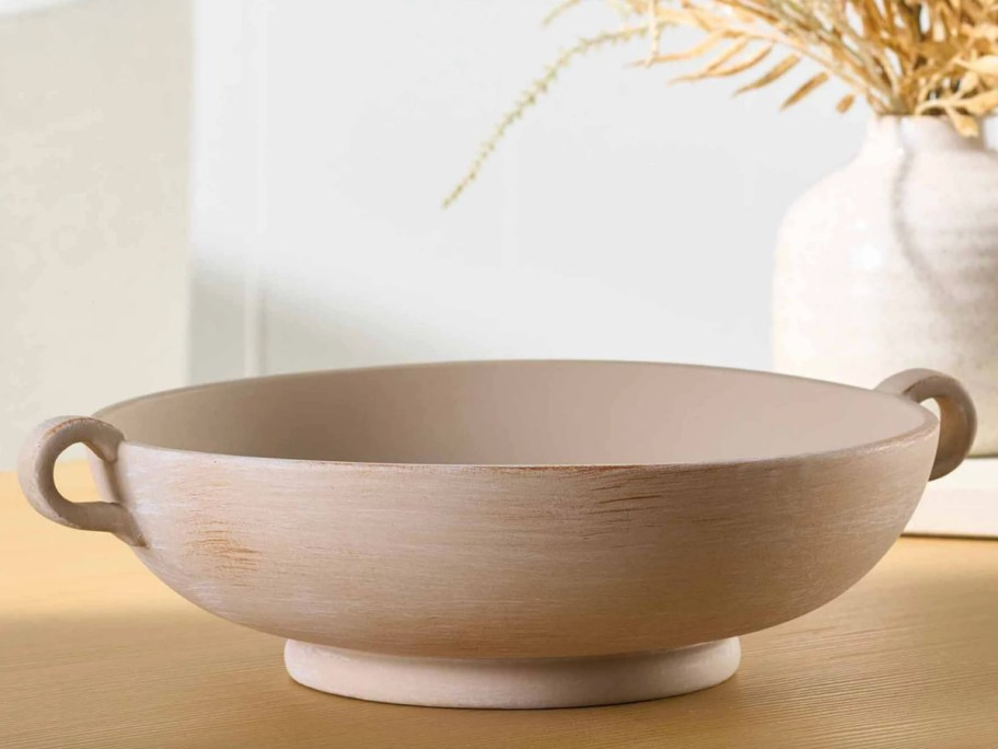 tan stone bowl with handles