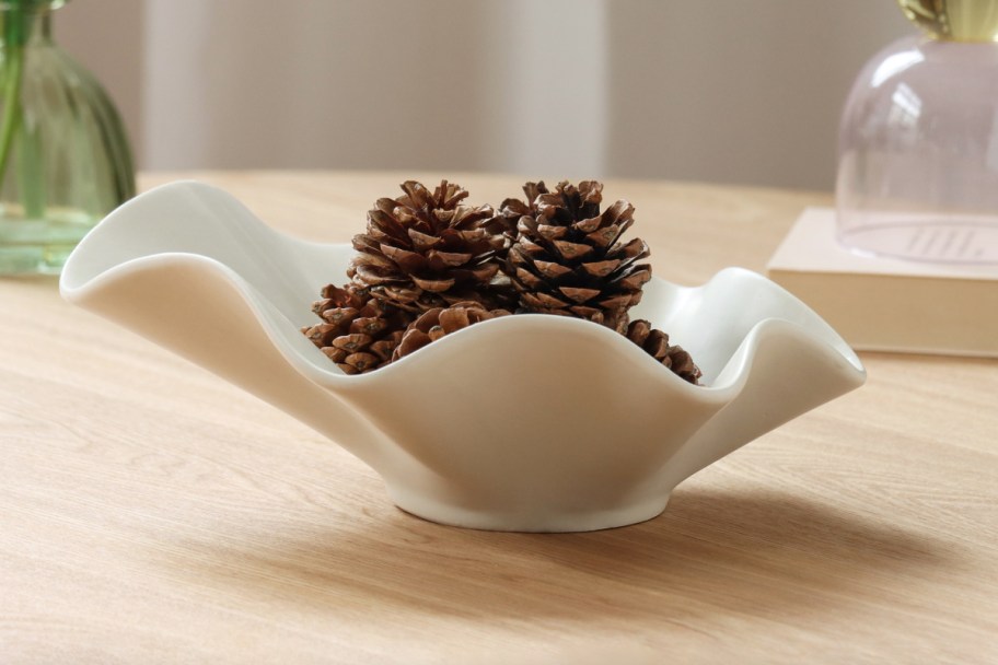 wavy white bowl with pinecones