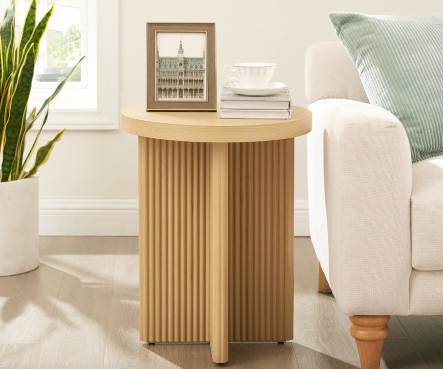 round fluted end table next to white couch
