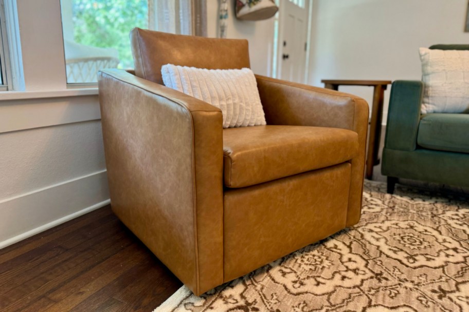 square leather chair with cream pillow