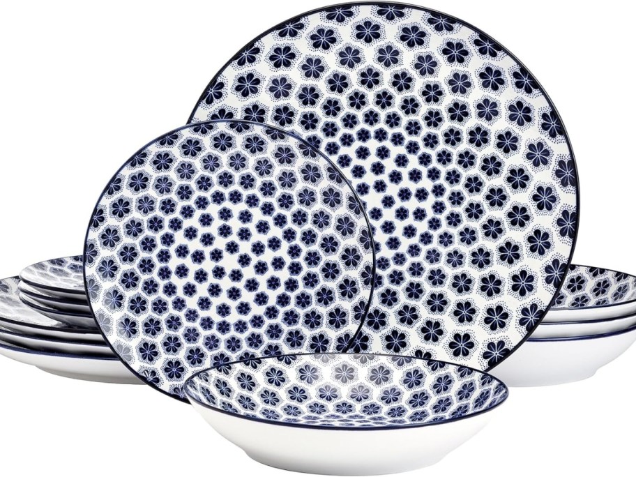 a set of plates and bowls in a blue floral print