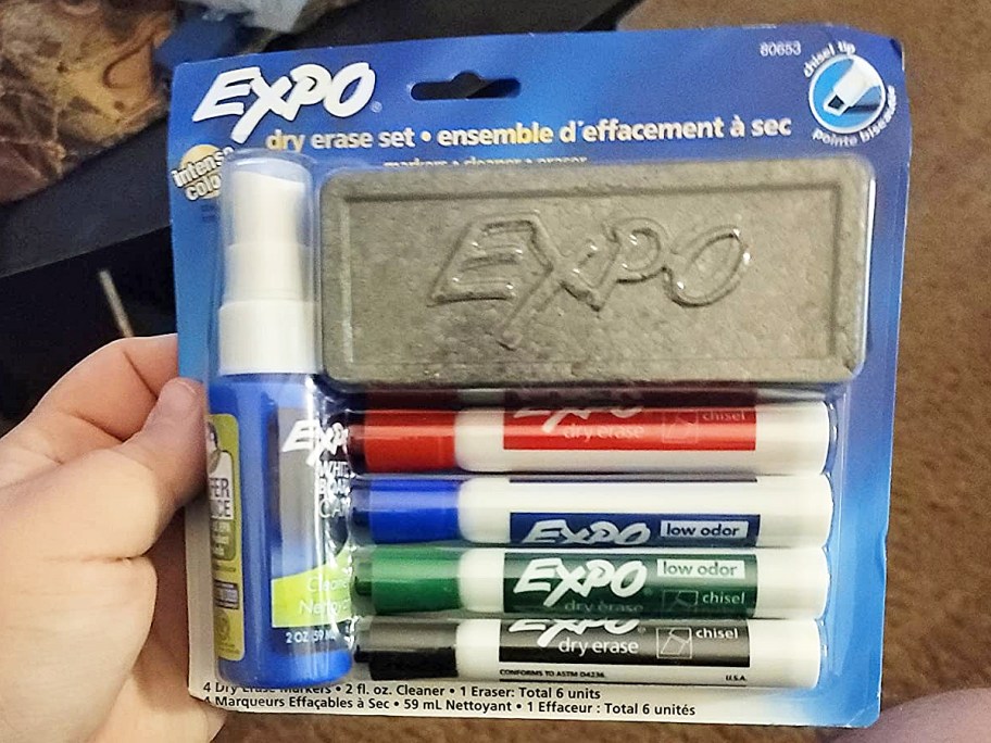 hand holding a pack of EXPO Dry Erase Markers with eraser and spray