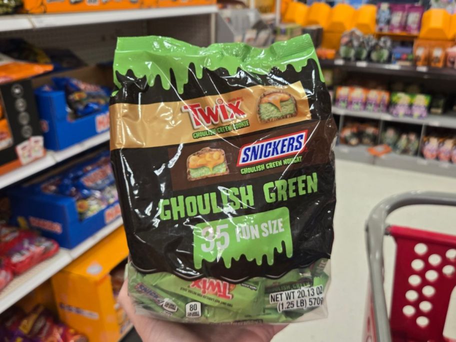 A person holding a bag of candy in a store