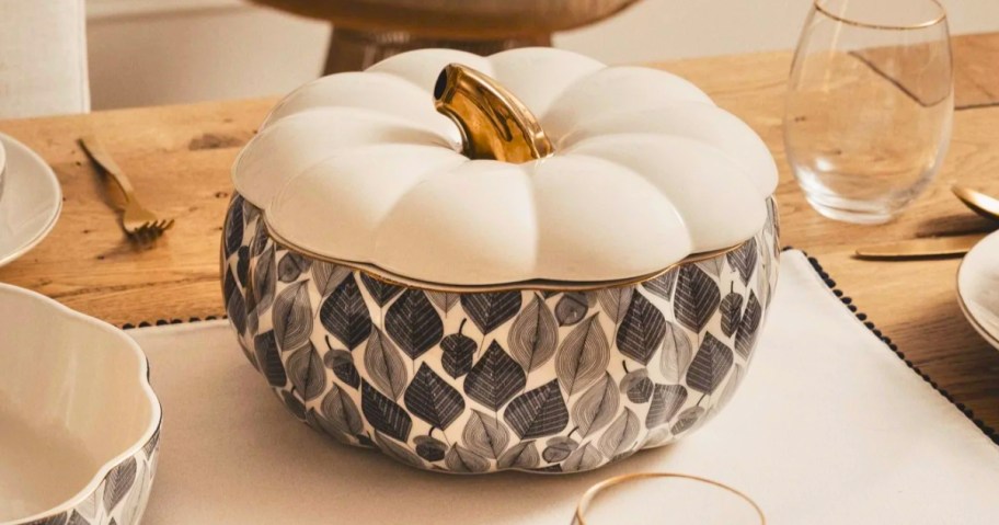 a large pumpkin shaped soup tureen on a table