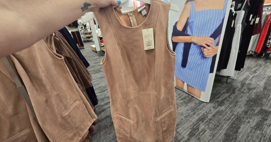 hand holding a tan suede mini dress at Target