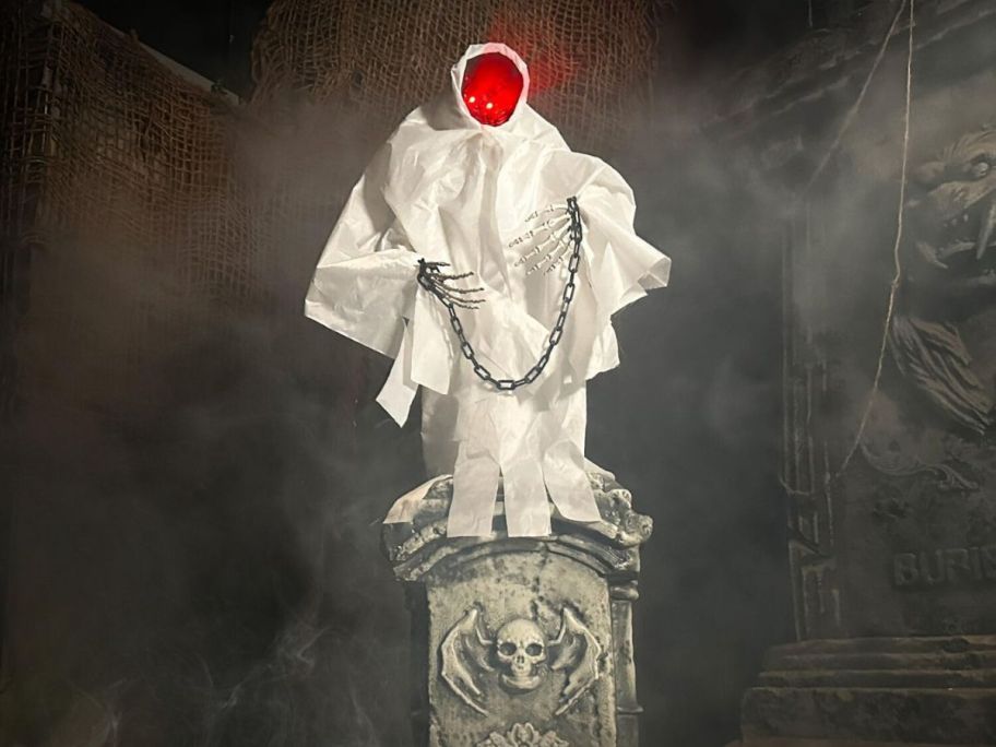 White robed figure on a tomb