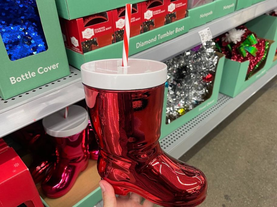 hand holding Holiday Time Plastic Santa Boot Christmas Cup w Lid and Straw