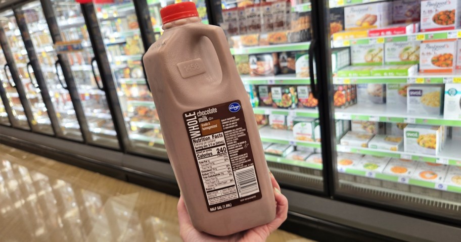 hand holding up a half gallon of Kroger Chocolate Milk in store