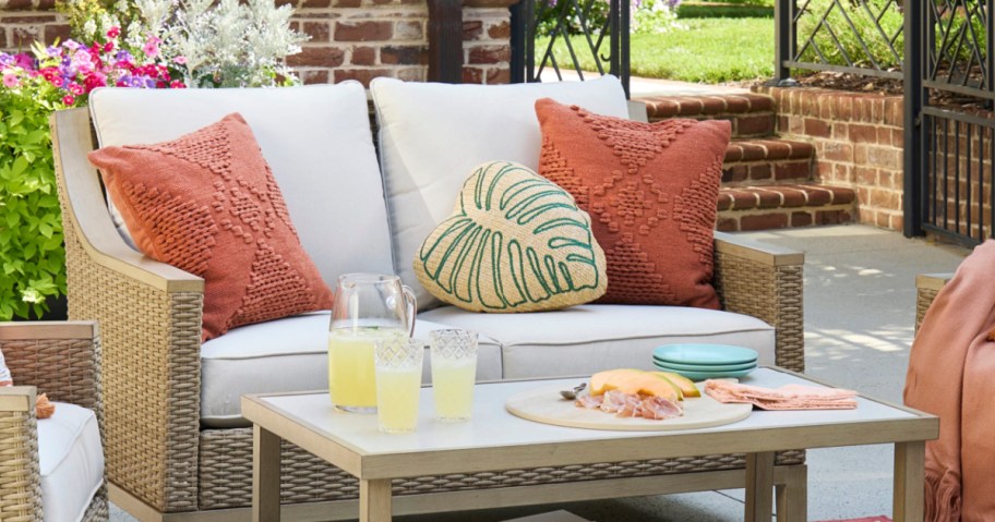 Lowe's patio loveseat and table with throw pillows